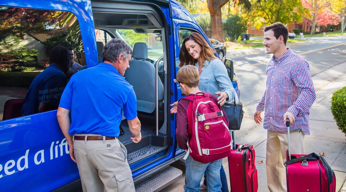 Family boarding a SuperShuttle van
